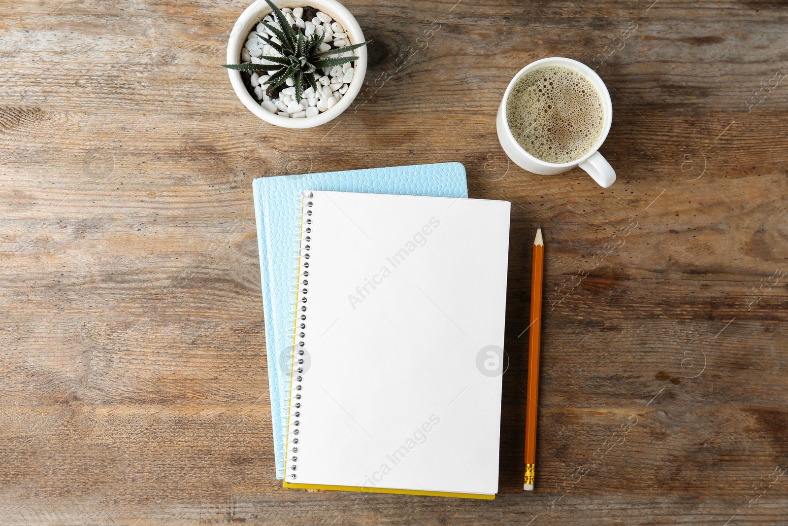 Photo of Flat lay composition with office stationery and cup of coffee on wooden table. Space for design