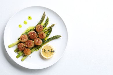 Photo of Delicious fried scallops with asparagus, lemon and thyme on white background, top view. Space for text