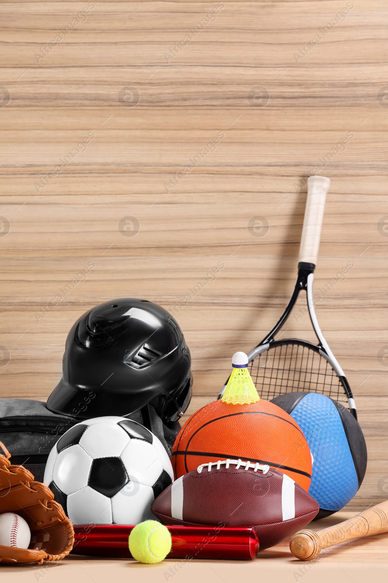 Photo of Many different sports equipment on wooden table