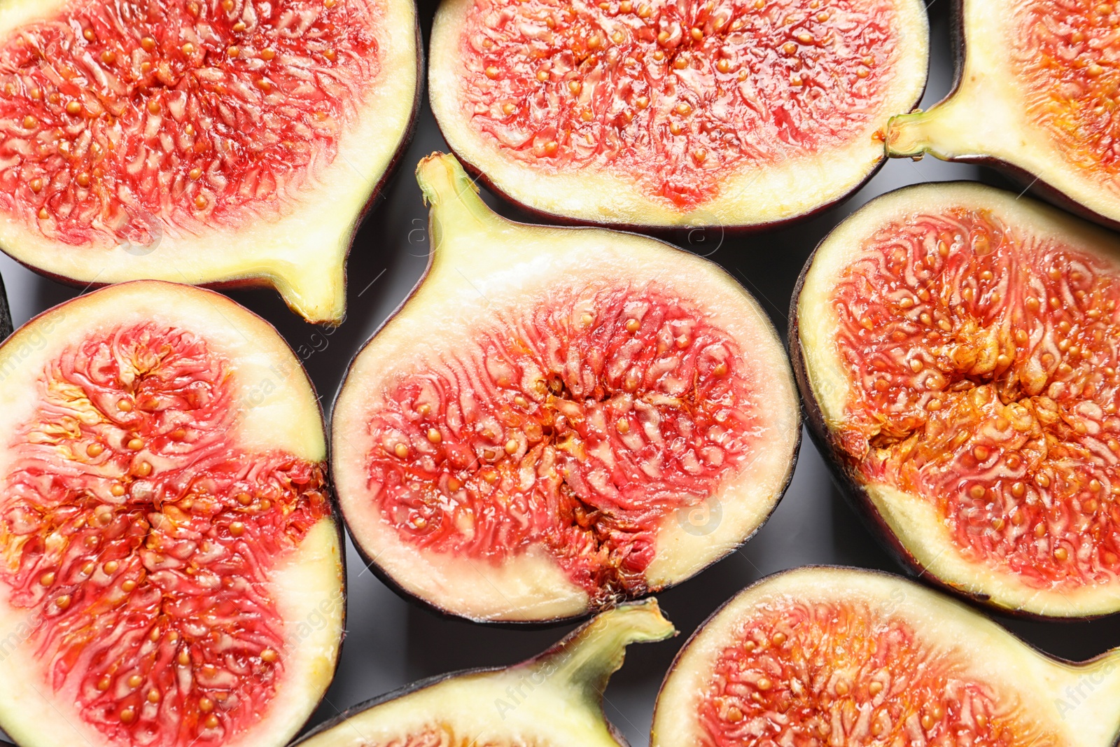 Photo of Cut ripe figs as background, top view