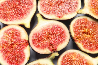 Photo of Cut ripe figs as background, top view