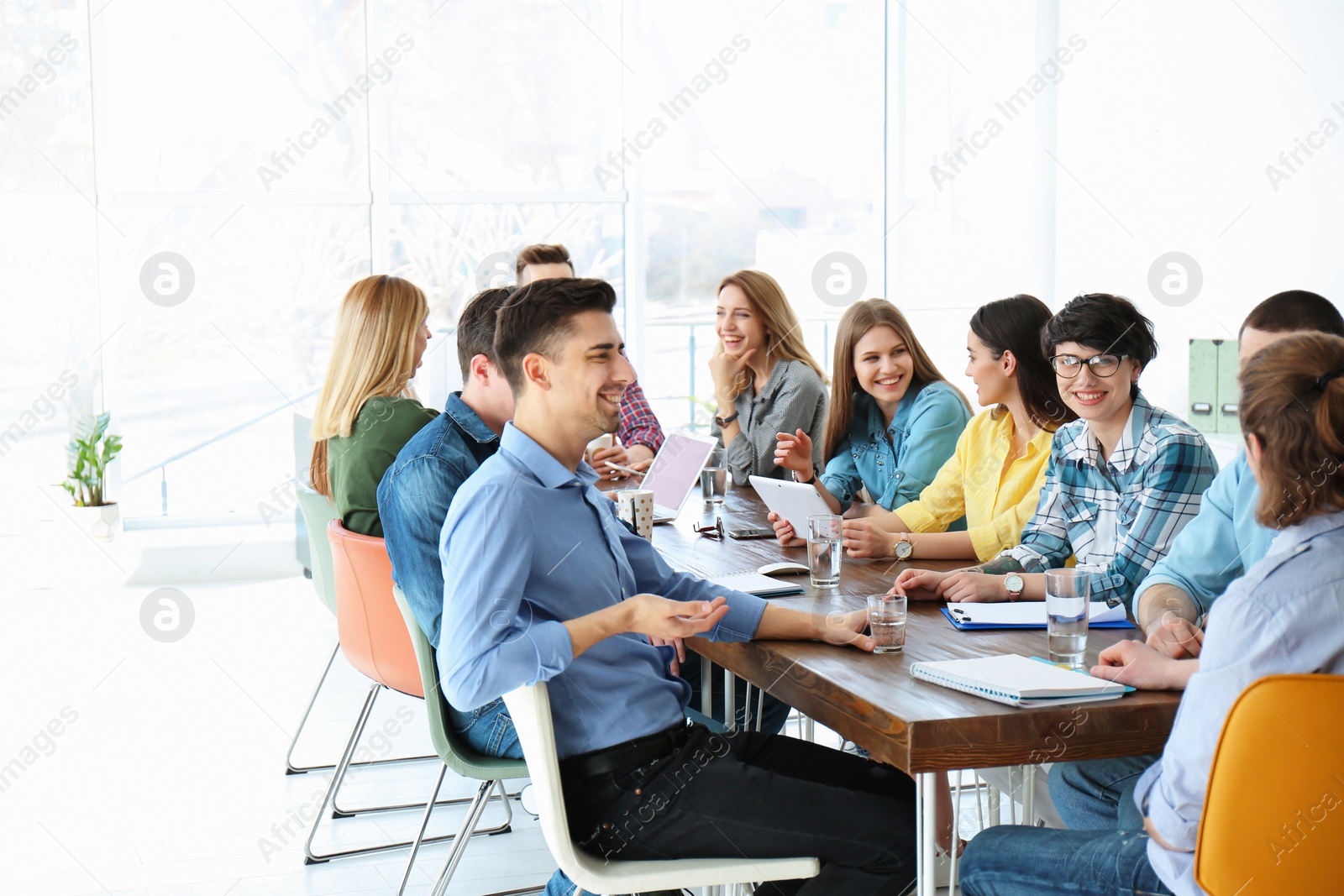 Photo of Young people having business training in office