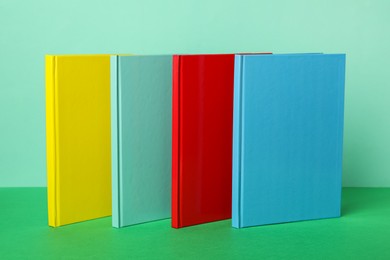 Photo of New stylish bright planners on color background
