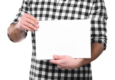 Man holding sheet of paper on light grey background, closeup. Mockup for design