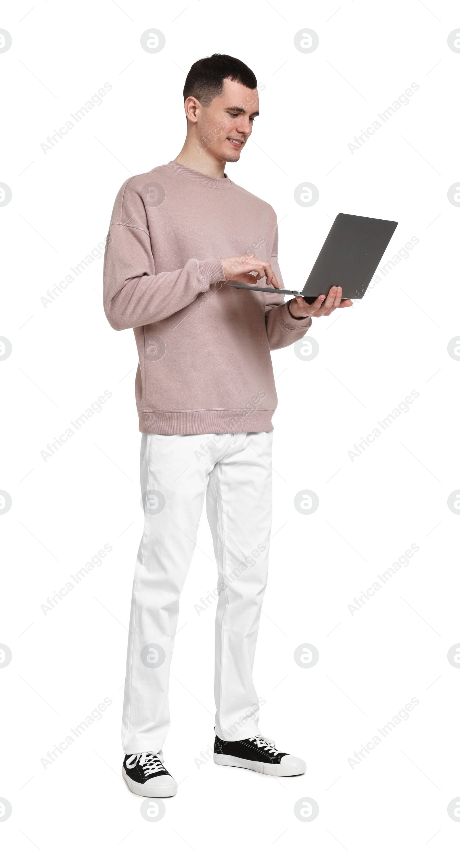 Photo of Handsome young man with laptop on white background