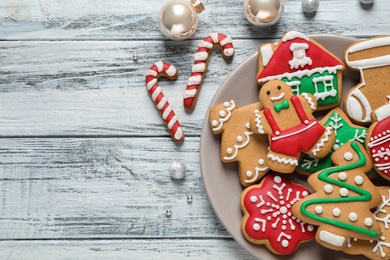Photo of Flat lay composition with tasty homemade Christmas cookies on white wooden table, space for text