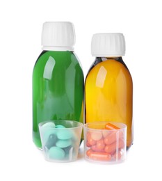 Bottles of syrups with pills on white background. Cough and cold medicine