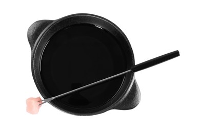 Photo of Fondue pot and fork with raw piece of meat isolated on white, top view
