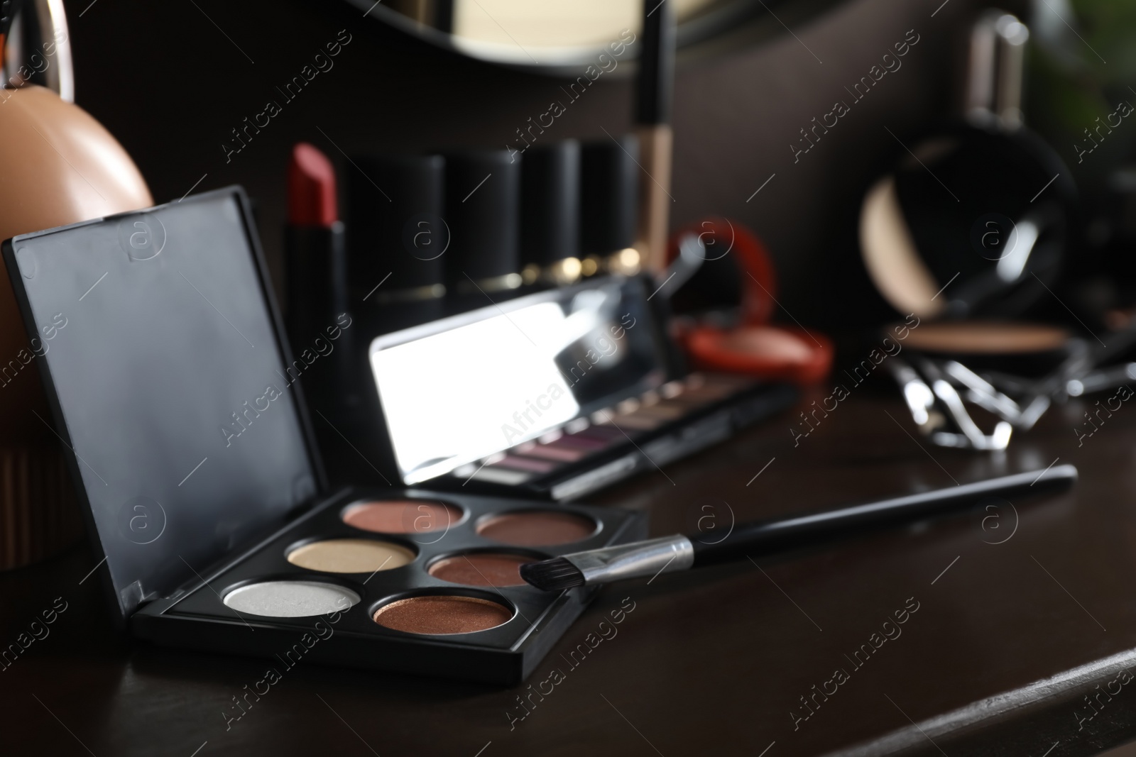 Photo of Stylish dressing table with different cosmetic products