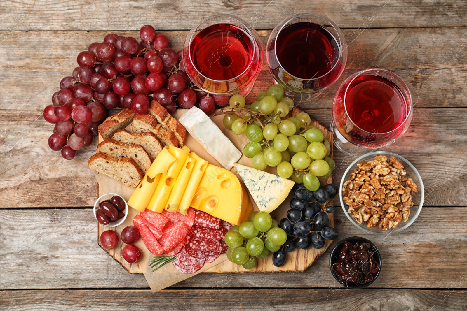 Photo of Flat lay composition with wine and snacks on wooden background