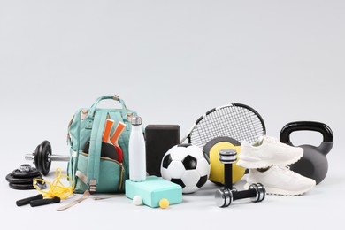 Many different sports equipment on light grey background