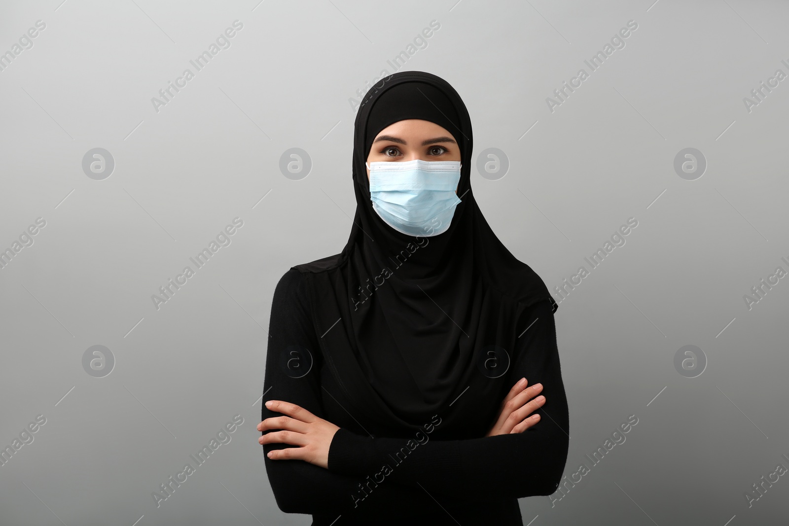 Photo of Portrait of Muslim woman in hijab on light gray background