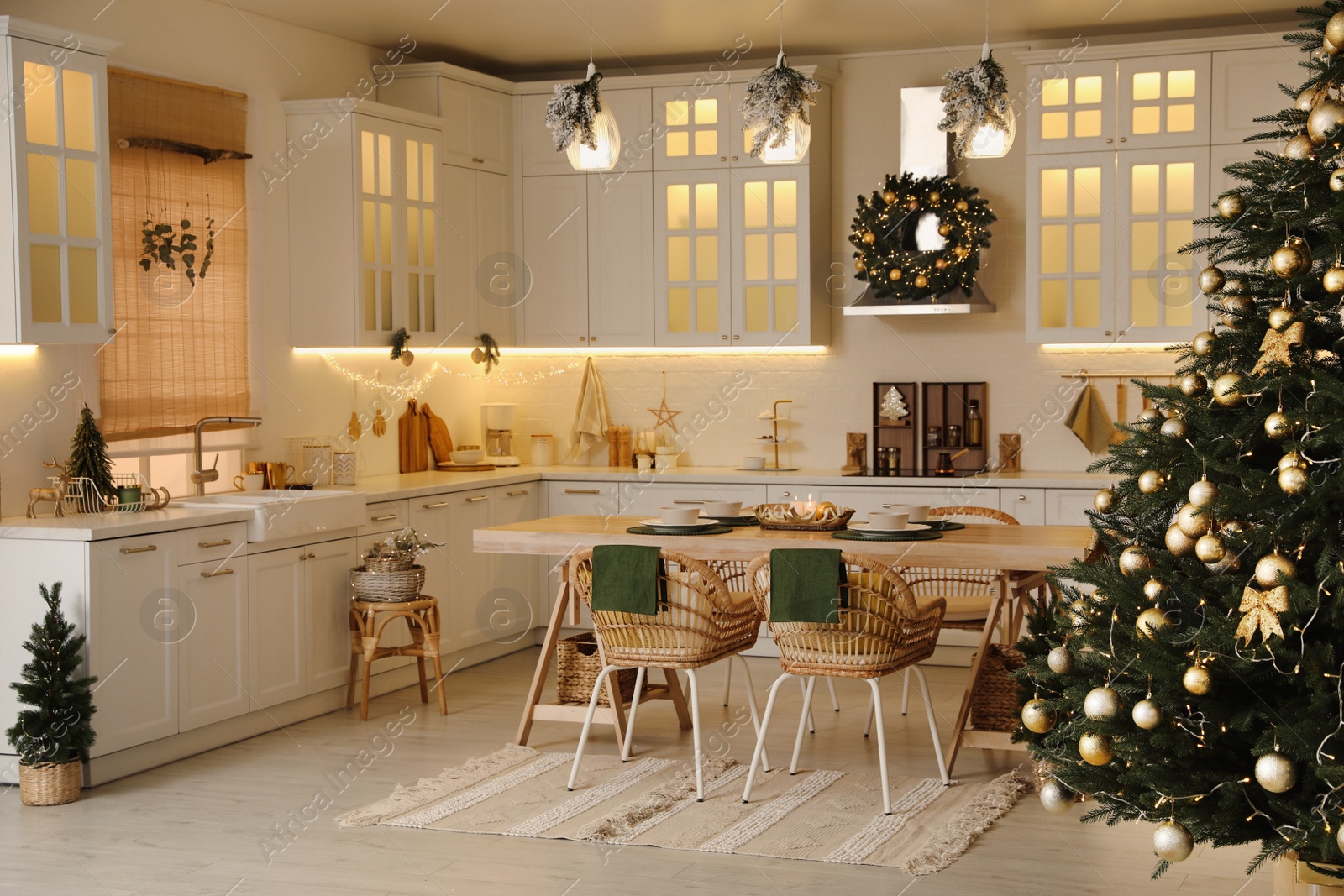 Photo of Cozy open plan kitchen decorated for Christmas. Interior design