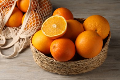 Photo of Many whole and cut oranges on wooden table