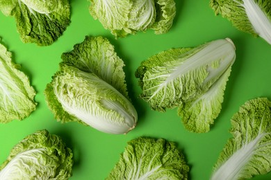 Fresh ripe Chinese cabbages on light green background, flat lay
