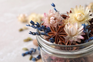 Photo of Aroma potpourri with different spices in jar, closeup view. Space for text