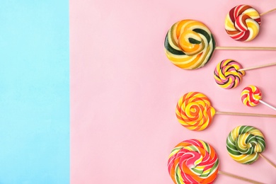 Flat lay composition with different yummy candies and space for text on color background