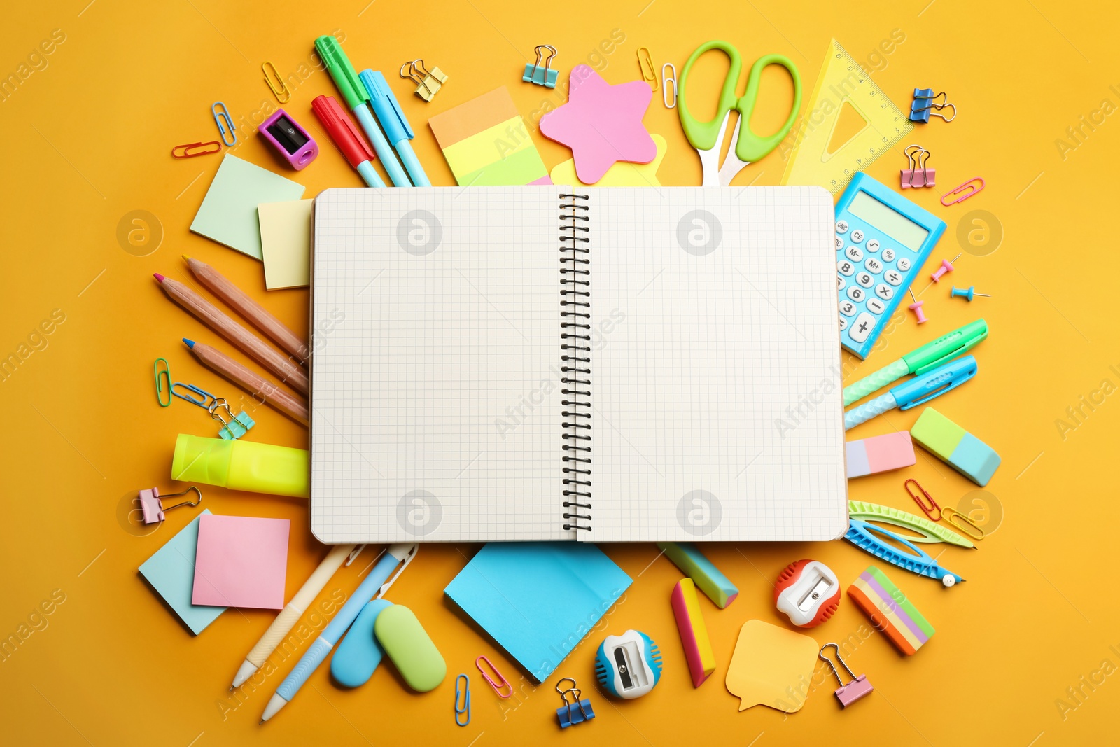 Photo of Blank notebook and school stationery on orange background, flat lay with space for text. Back to school