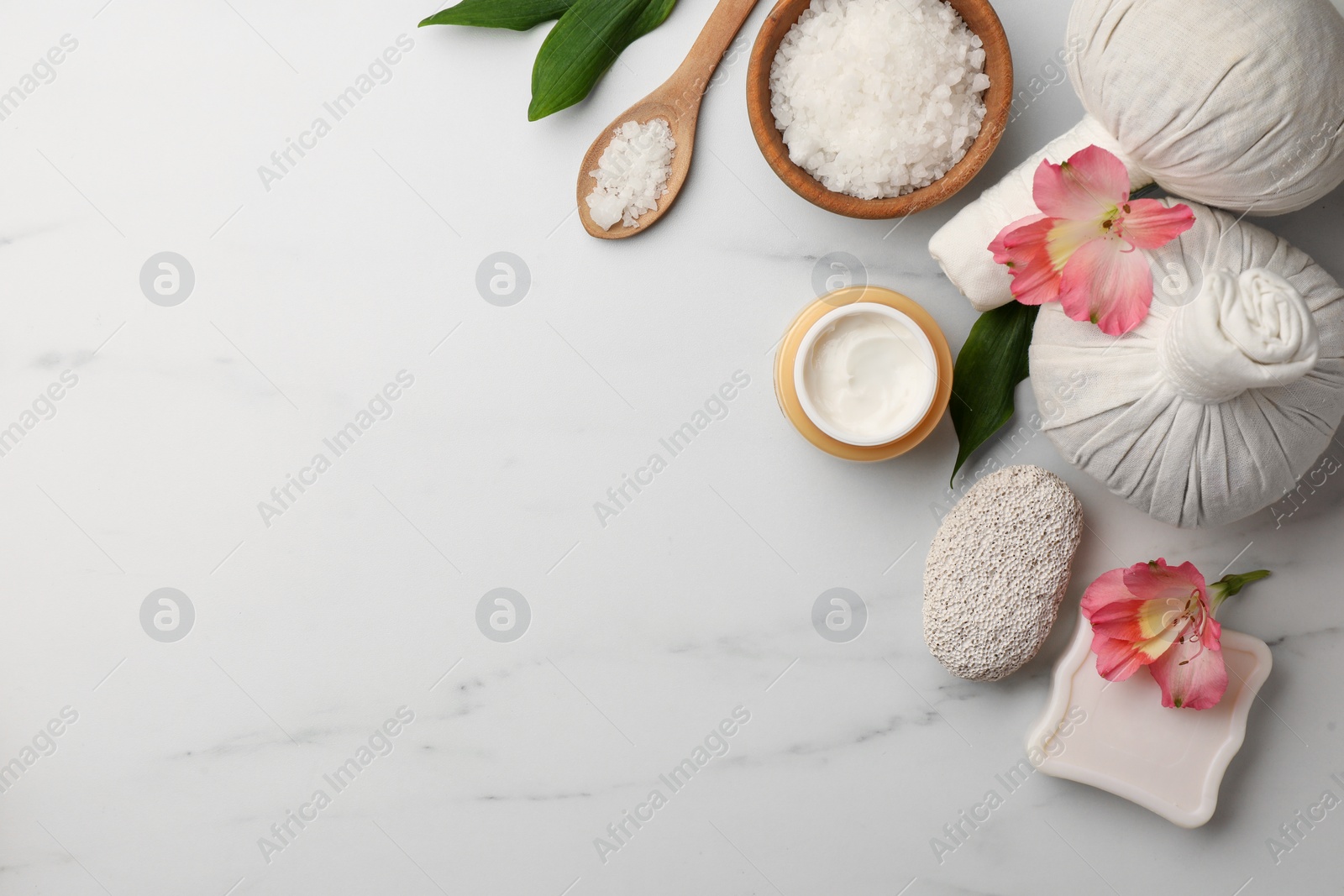 Photo of Flat lay composition with spa products and flowers on white marble table. Space for text