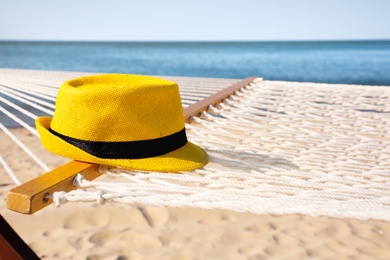 Photo of Hammock and hat at seaside. Time to relax