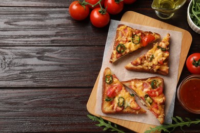 Photo of Tasty pizza toasts and ingredients on wooden table, flat lay. Space for text