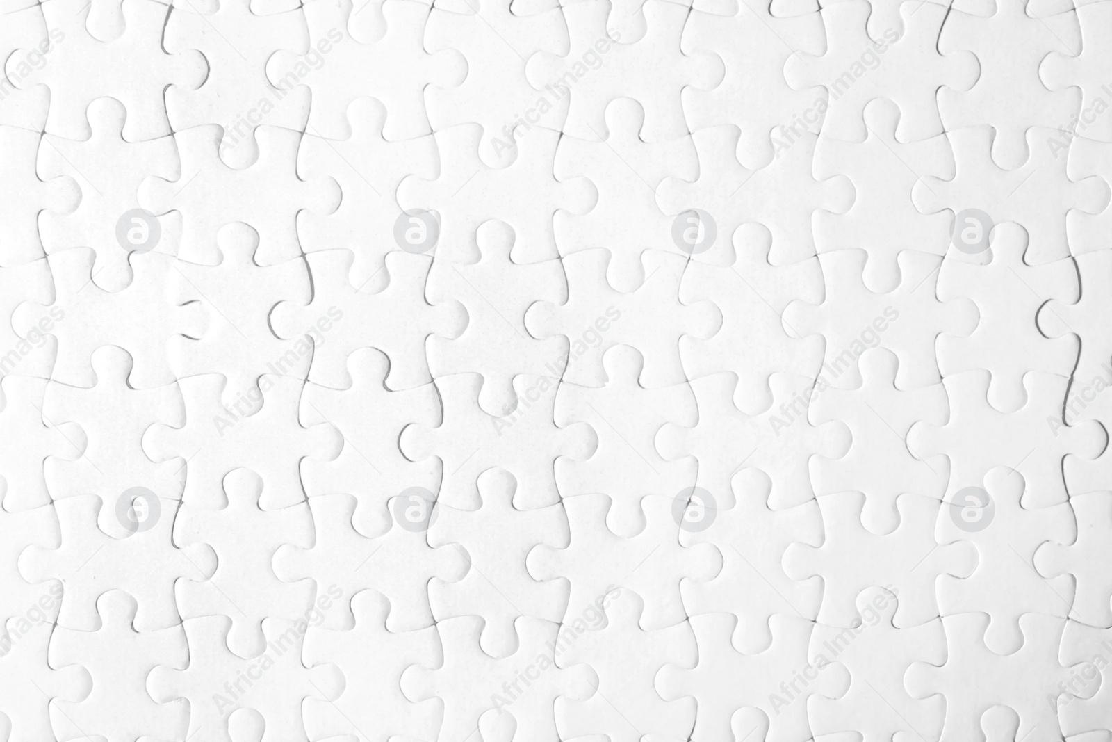 Photo of Blank white puzzle as background, top view