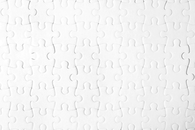 Photo of Blank white puzzle as background, top view