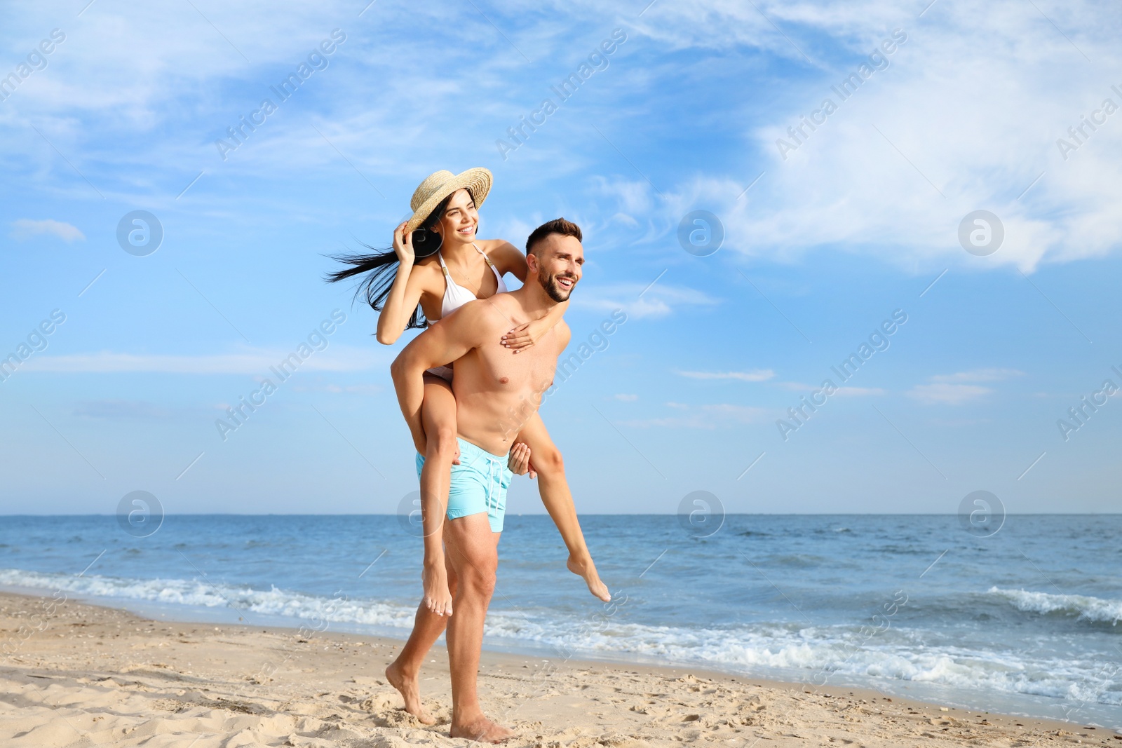 Photo of Happy young couple having fun on beach