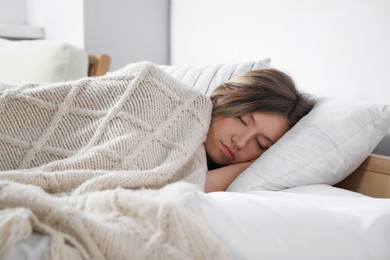 Photo of Tired young woman sleeping in bed indoors