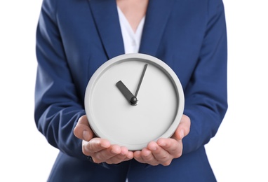 Young businesswoman holding clock on white background. Time management