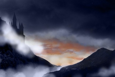 Image of Fantasy world. Mystical castle and mountains covering with fog in night