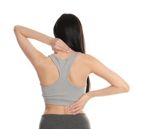 Woman suffering from pain in back on white background. Visiting orthopedist