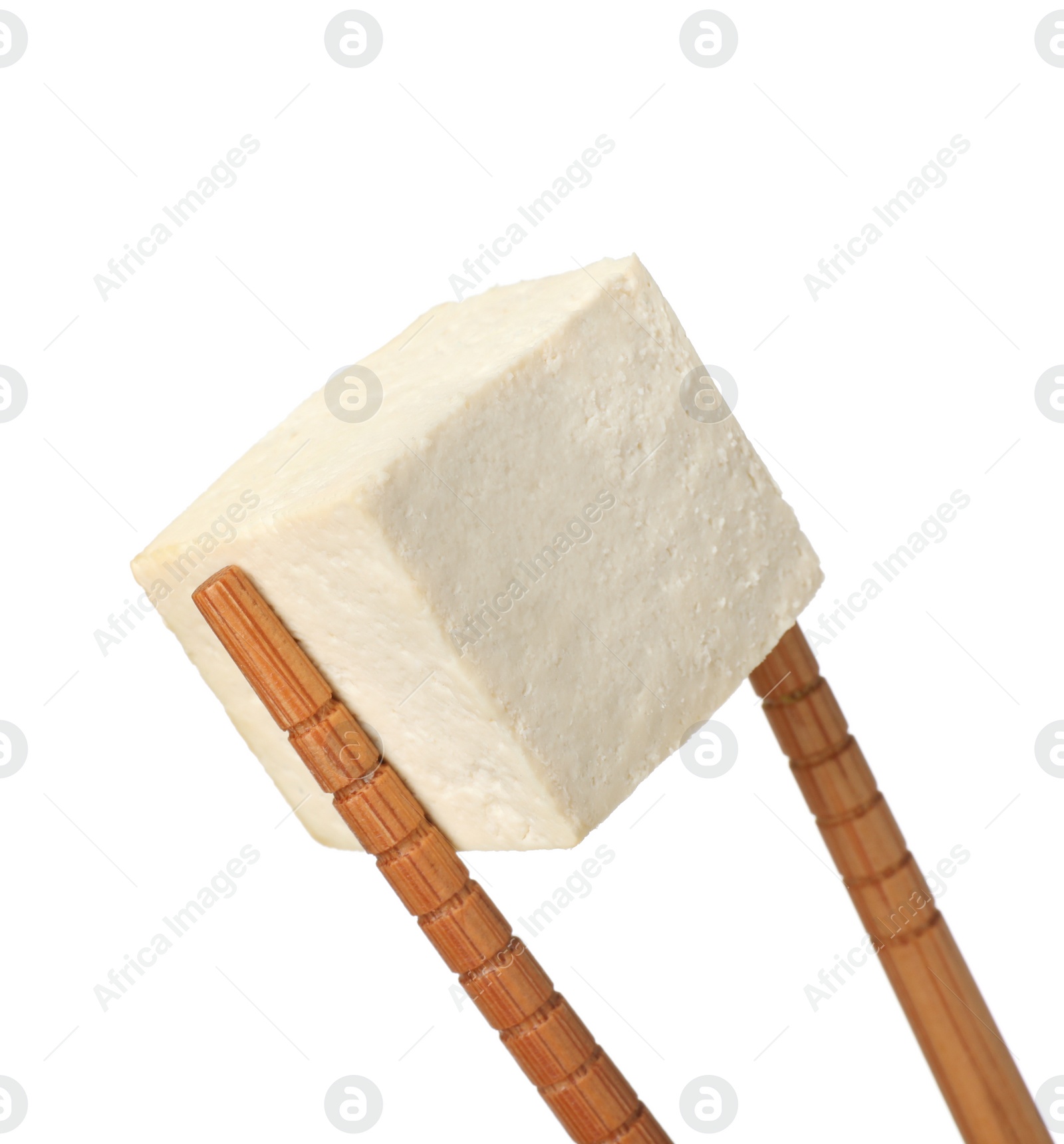 Photo of Chopsticks with delicious raw tofu cube isolated on white