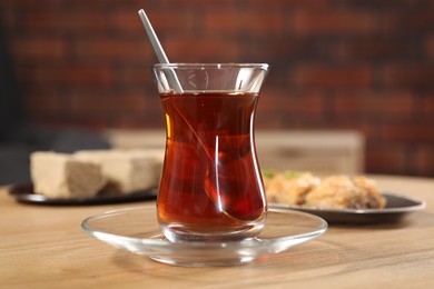 Traditional Turkish tea in glass on wooden table