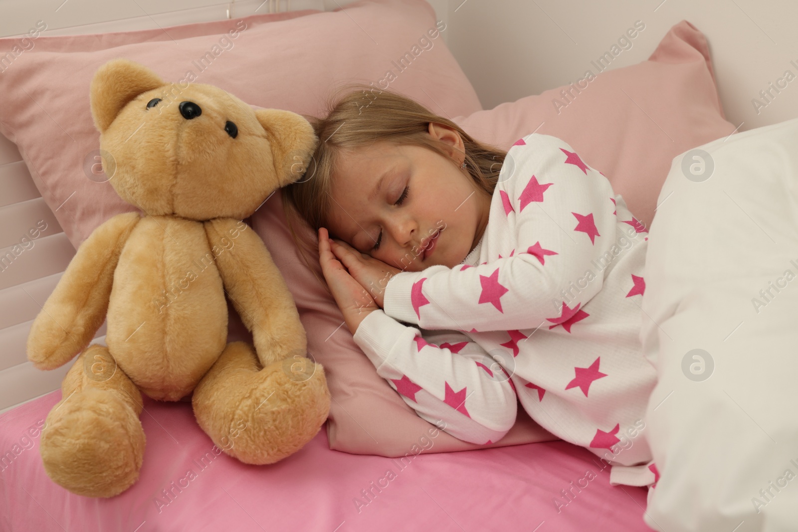 Photo of Little girl snoring while sleeping in bed