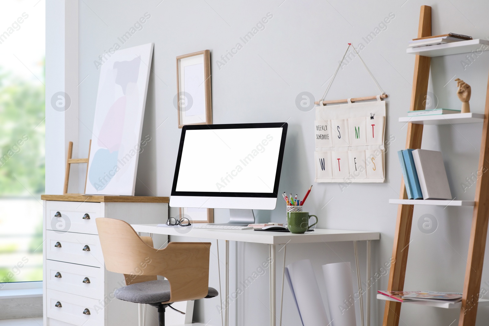 Photo of Comfortable workplace with modern computer and stylish furniture in room. Interior design