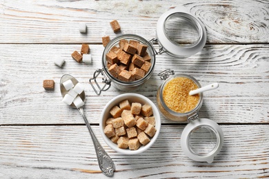 Photo of Composition with various kinds of sugar on wooden background, top view