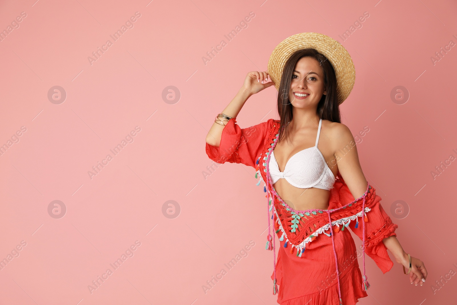 Photo of Pretty sexy woman with slim body in stylish  white bikini on coral background. Space for text