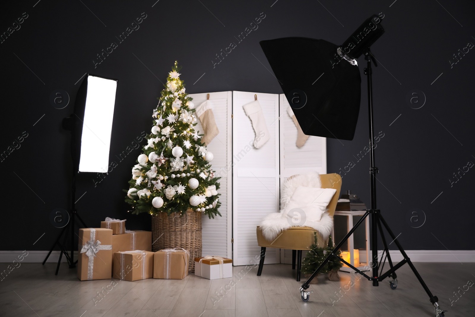 Photo of Beautiful photo zone with professional equipment and  decorated Christmas tree