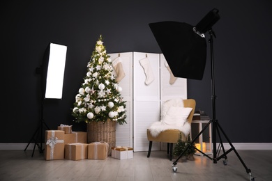 Photo of Beautiful photo zone with professional equipment and  decorated Christmas tree