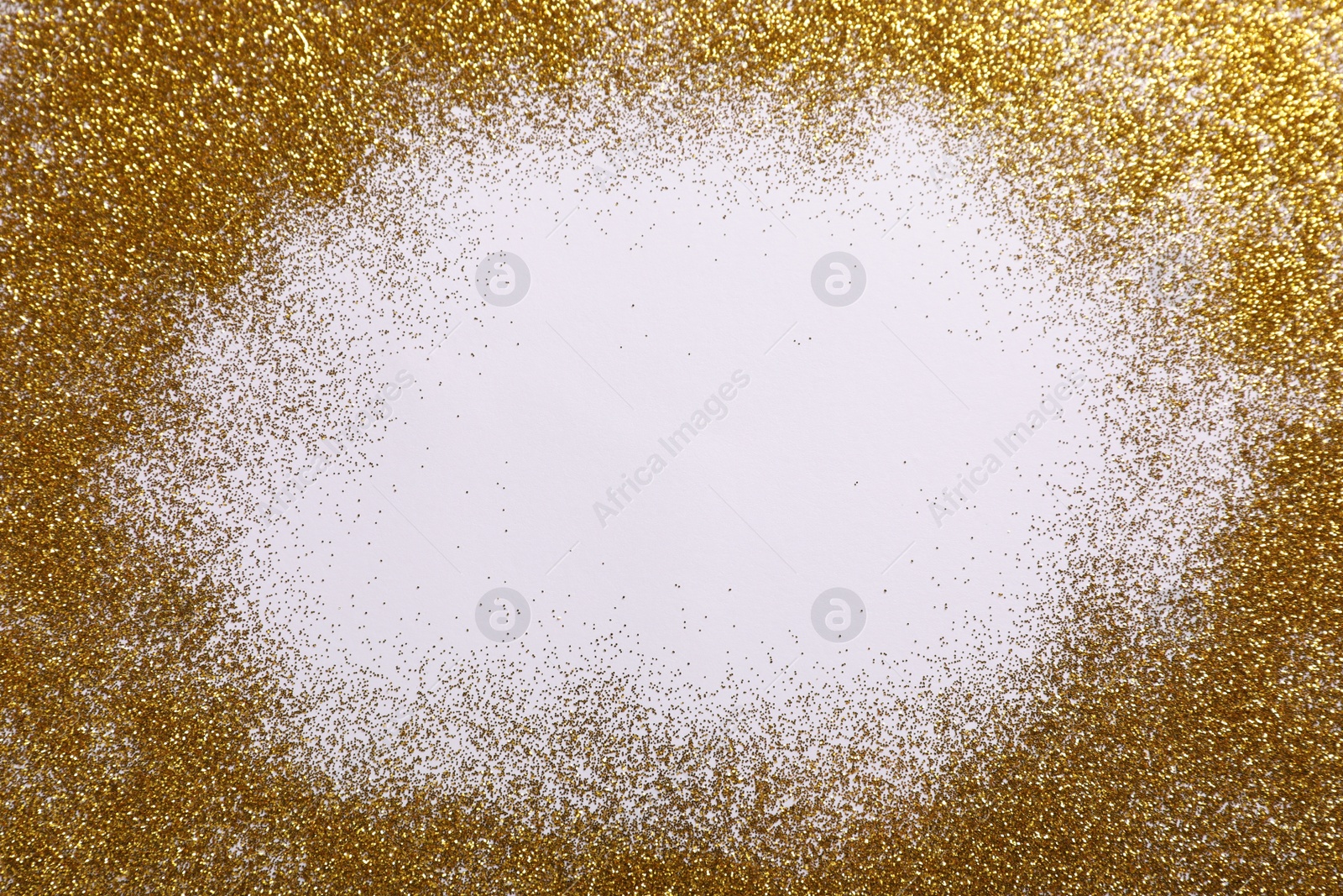 Photo of Frame made of shiny golden glitter on white background, top view