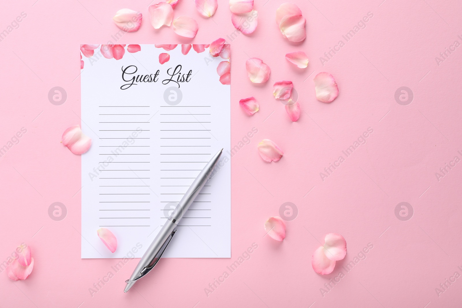Photo of Guest list, pen and petals on pink background, flat lay. Space for text