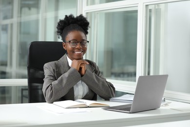 Happy woman working at table in office. Lawyer, businesswoman, accountant or manager