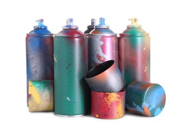 Photo of Many spray paint cans with caps isolated on white