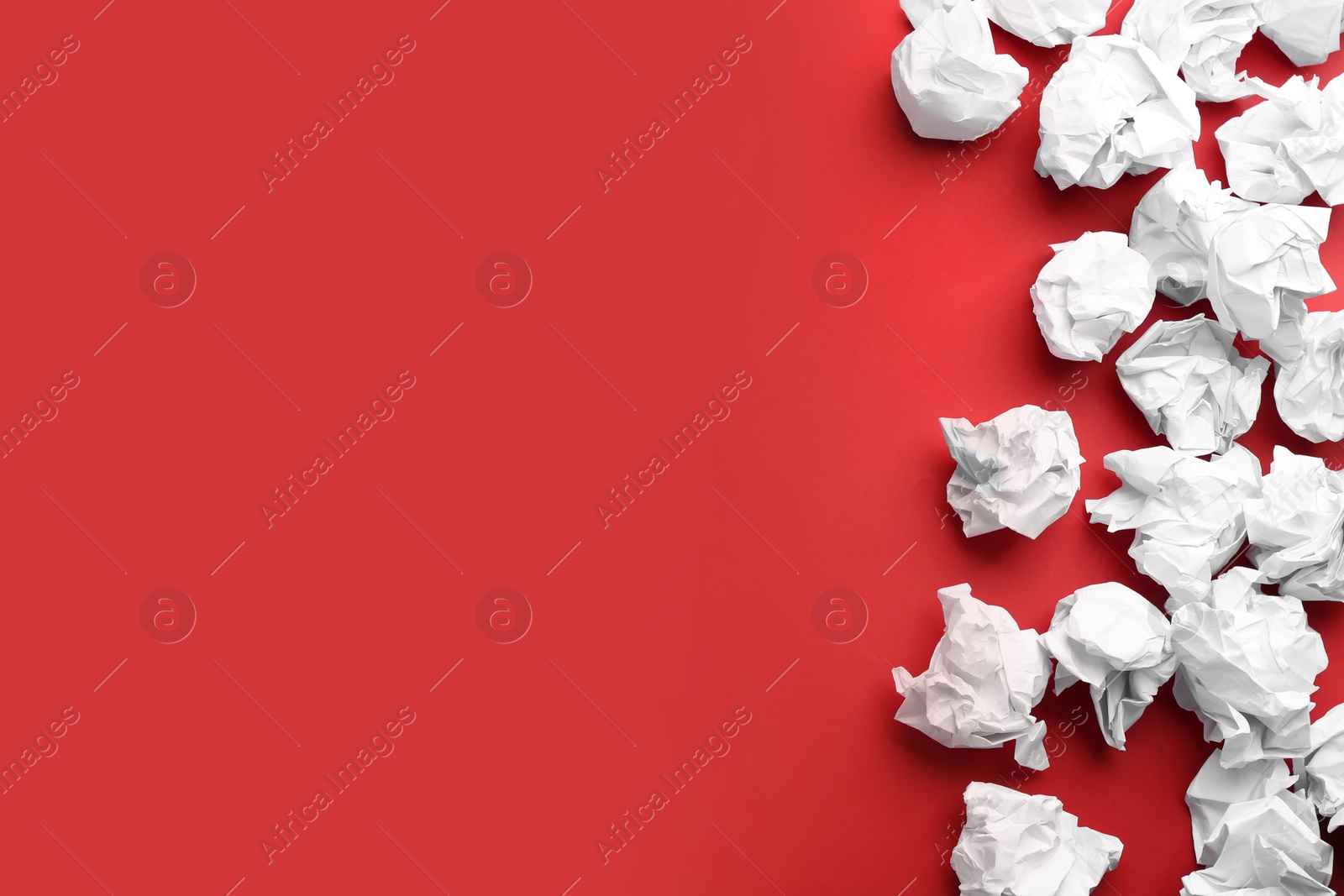 Photo of Crumpled sheets of paper on red background, flat lay. Space for text
