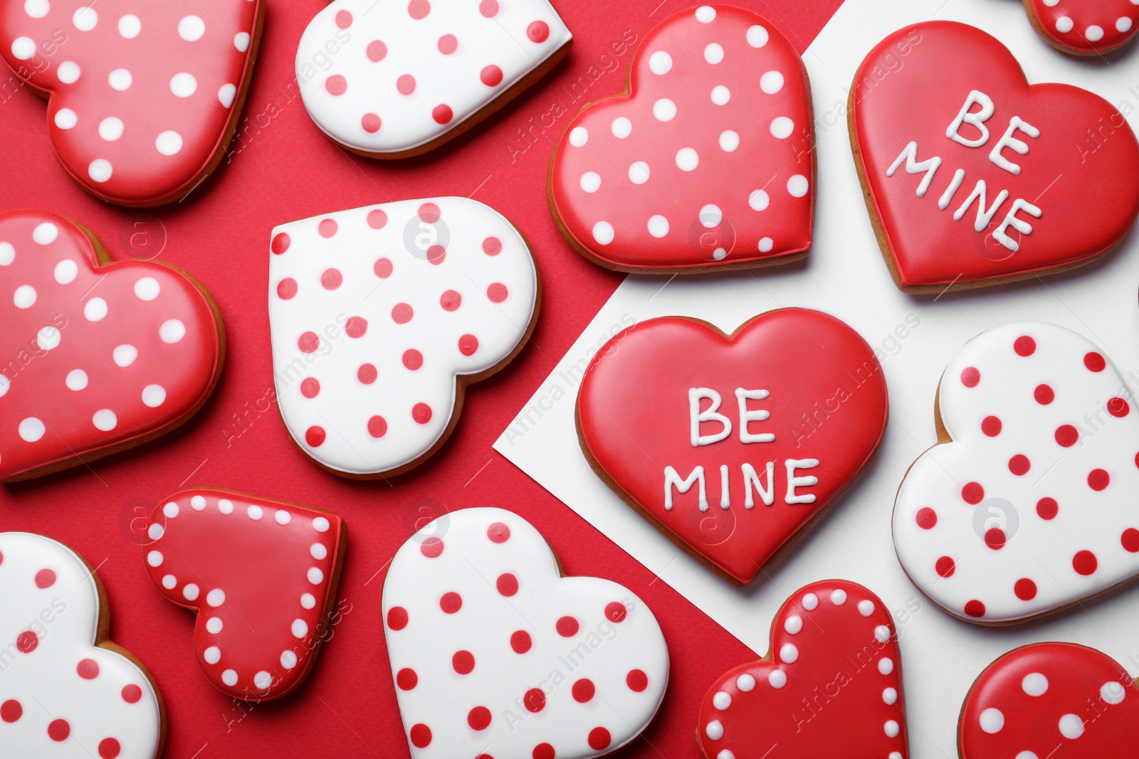 Photo of Decorated heart shaped cookies on color background, flat lay. Valentine's day treat