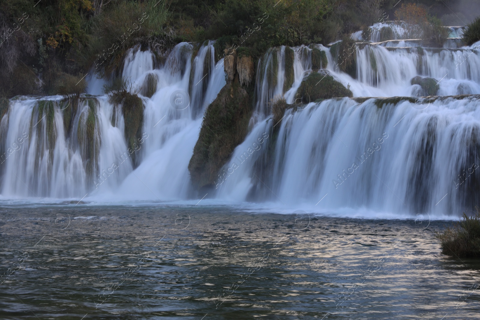 Photo of Picturesque view of beautiful waterfall and rocks outdoors