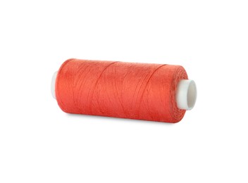 Photo of Spool of coral sewing thread isolated on white