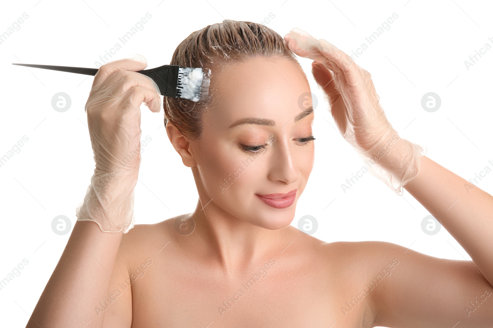 Photo of Young woman dyeing her hair against white background