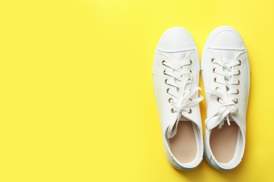 Photo of Stylish sneakers on color background, top view with space for text